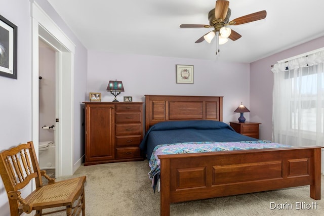 bedroom featuring a ceiling fan, light carpet, and baseboards