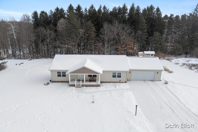 snowy aerial view with a forest view