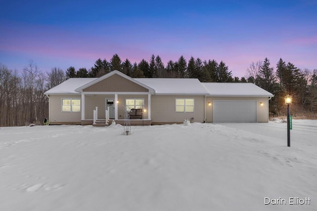 ranch-style house with an attached garage and a porch