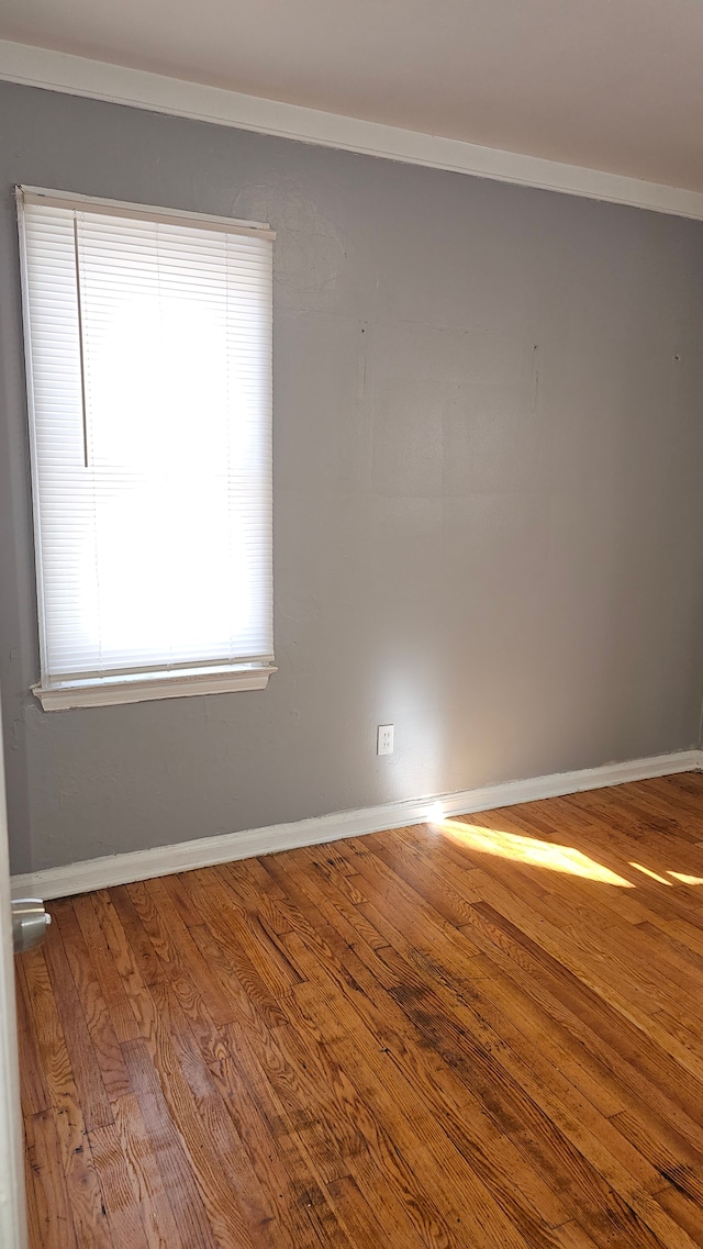 empty room with wood finished floors and baseboards