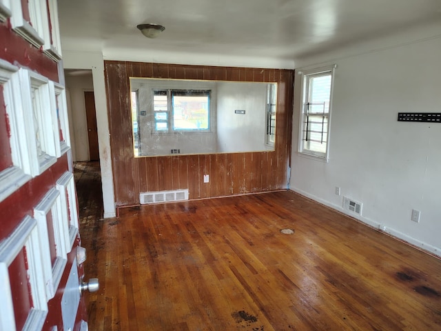 18401 Justine St, Detroit, MI 48234 - foyer entrance with visible vents, wood walls, and hardwood / wood-style floors