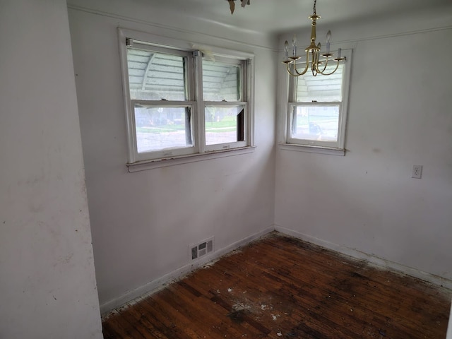 18401 Justine St, Detroit, MI 48234 - unfurnished room with visible vents, baseboards, a notable chandelier, and hardwood / wood-style floors
