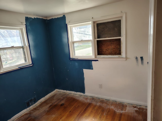 18401 Justine St, Detroit, MI 48234 - empty room featuring baseboards, plenty of natural light, wood finished floors, and visible vents