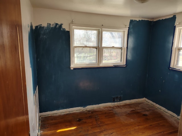 18401 Justine St, Detroit, MI 48234 - spare room with visible vents, baseboards, a healthy amount of sunlight, and hardwood / wood-style floors