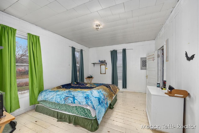 bedroom featuring light wood-type flooring and multiple windows