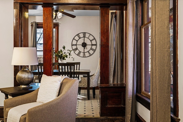 living area featuring a ceiling fan