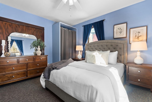 bedroom featuring dark colored carpet and a ceiling fan