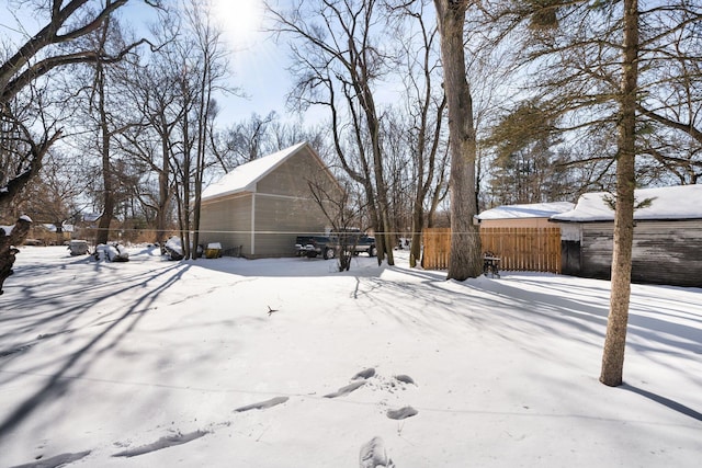 snowy yard with fence