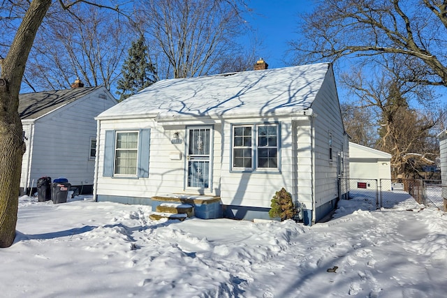 18953 Woodcrest St, Harper Woods, MI 48225 - view of front of house featuring a garage, a chimney, and fence