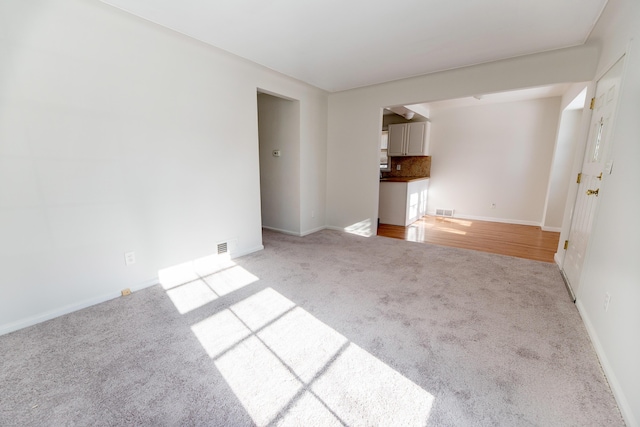 18953 Woodcrest St, Harper Woods, MI 48225 - unfurnished living room featuring light colored carpet, visible vents, and baseboards