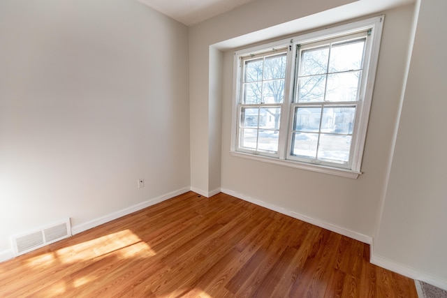 18953 Woodcrest St, Harper Woods, MI 48225 - spare room with baseboards, visible vents, and wood finished floors