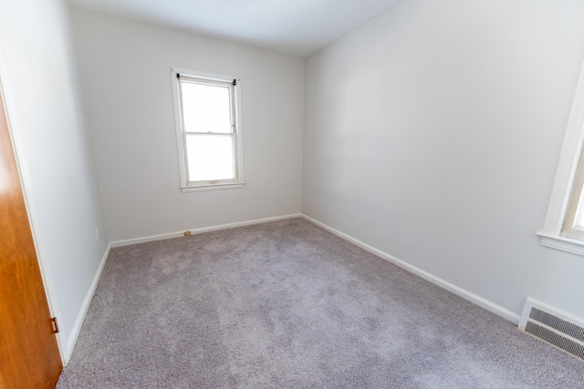 18953 Woodcrest St, Harper Woods, MI 48225 - spare room with baseboards, visible vents, and light colored carpet