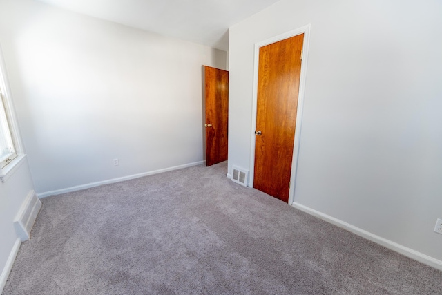 18953 Woodcrest St, Harper Woods, MI 48225 - unfurnished room featuring light colored carpet, visible vents, and baseboards