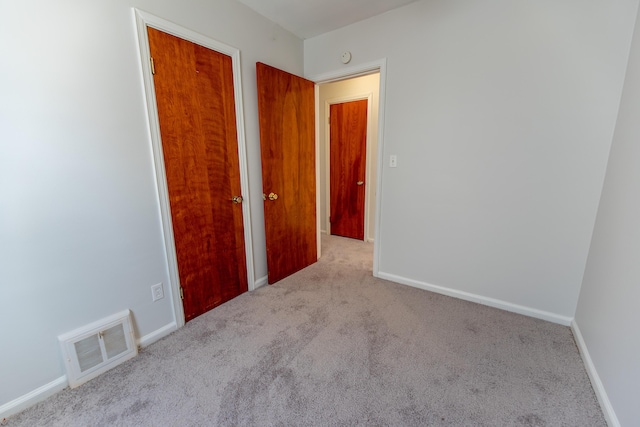 18953 Woodcrest St, Harper Woods, MI 48225 - spare room featuring visible vents, light carpet, and baseboards