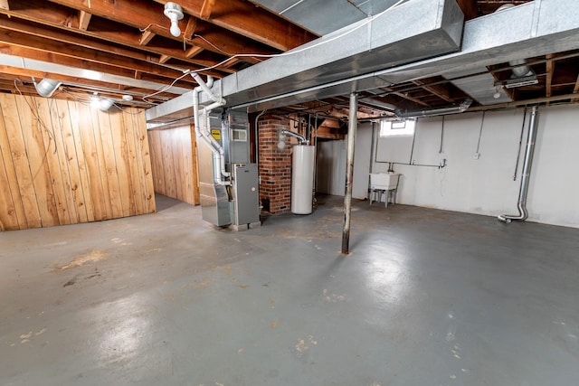 18953 Woodcrest St, Harper Woods, MI 48225 - below grade area featuring gas water heater, a sink, wooden walls, and heating unit