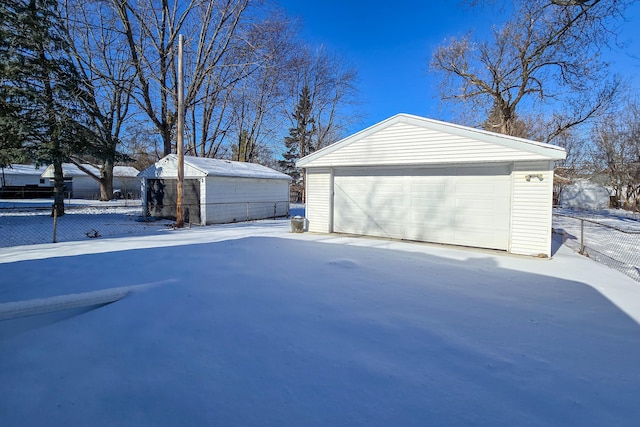 18953 Woodcrest St, Harper Woods, MI 48225 - snow covered garage with a garage and fence
