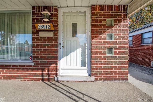 property entrance with brick siding