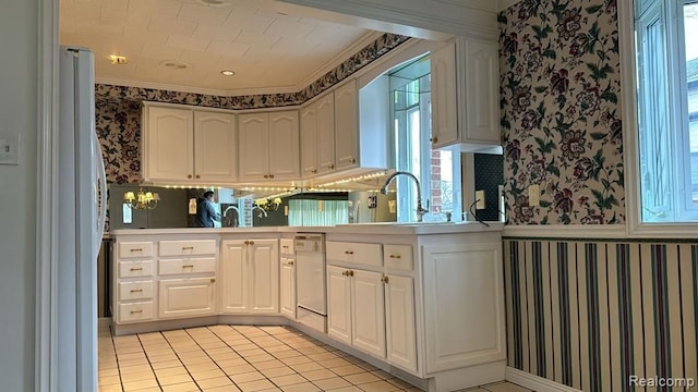 kitchen with wallpapered walls, white cabinetry, white appliances, and light countertops