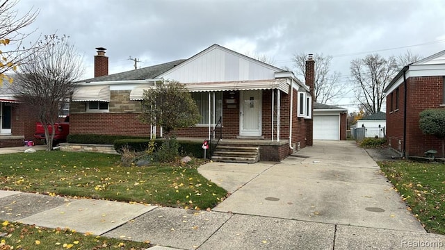 bungalow with a front yard, brick siding, and a chimney