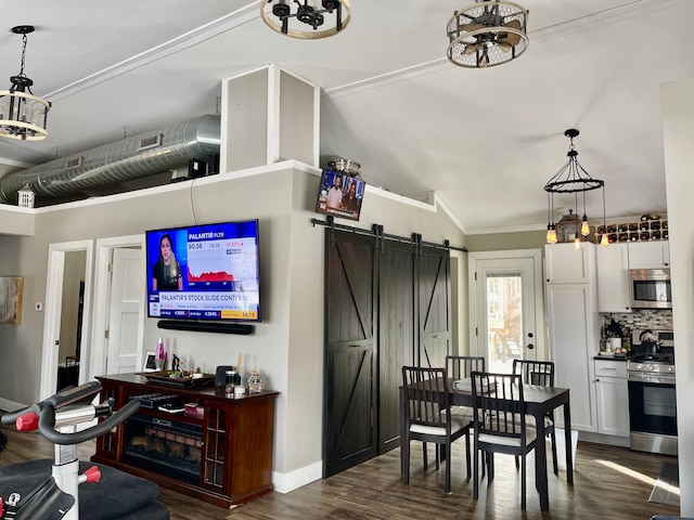 dining space with a barn door, visible vents, baseboards, dark wood finished floors, and crown molding