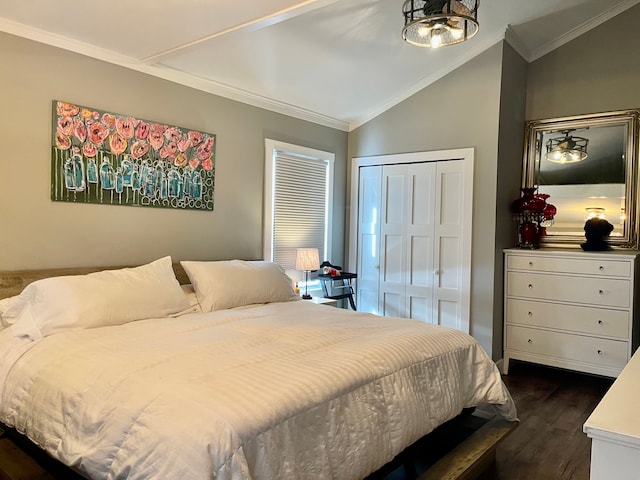 bedroom featuring vaulted ceiling, ornamental molding, a closet, and dark wood finished floors