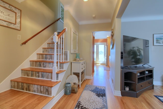 stairway featuring wood finished floors and baseboards