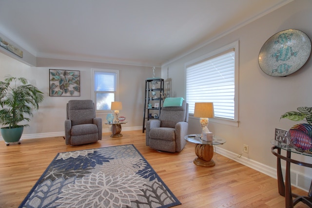 living area featuring plenty of natural light, wood finished floors, and baseboards