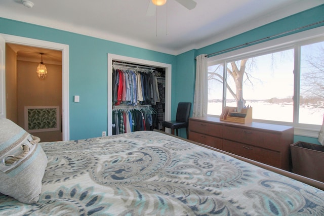 bedroom featuring multiple windows, a closet, and a ceiling fan