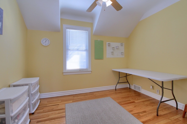 office featuring light wood-type flooring, baseboards, a ceiling fan, and lofted ceiling