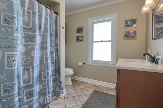 bathroom featuring baseboards, toilet, vanity, and tile patterned floors