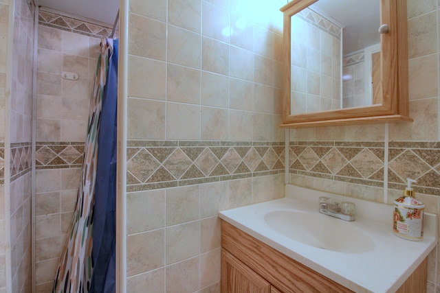 bathroom with vanity and tile walls