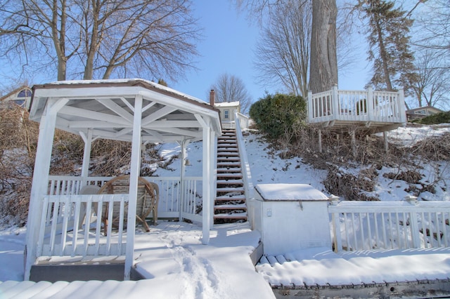 yard layered in snow featuring stairs and a gazebo