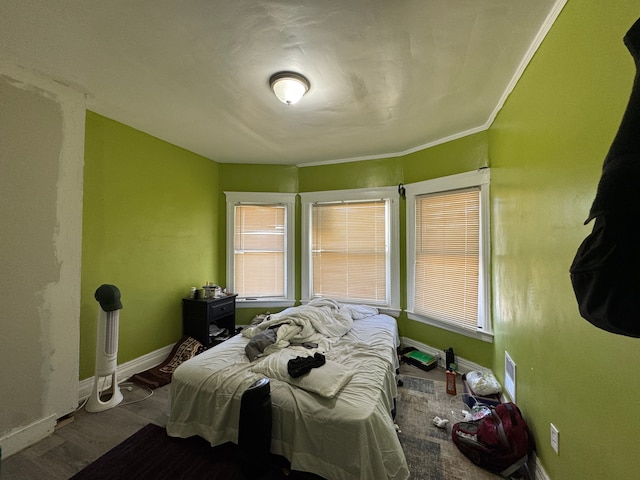 bedroom featuring baseboards and wood finished floors