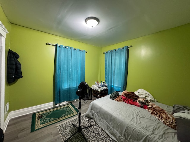 bedroom featuring baseboards and wood finished floors