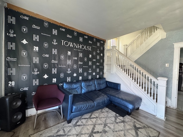 living room with wood finished floors and stairway