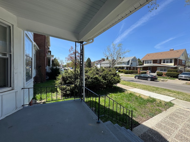balcony featuring covered porch and a residential view
