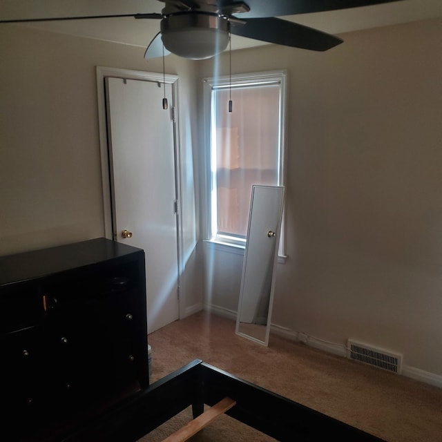 unfurnished bedroom with carpet, visible vents, ceiling fan, and baseboards