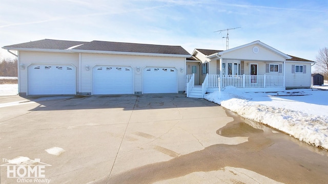 ranch-style house featuring driveway, covered porch, and an attached garage