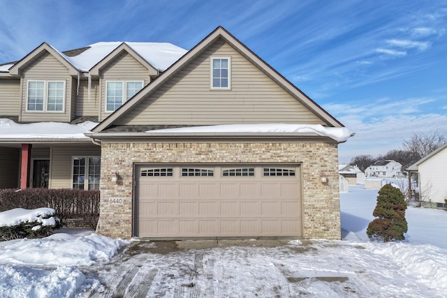 view of front of house featuring a garage and brick siding