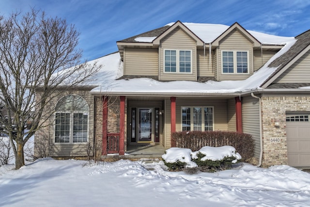 view of front of home with brick siding and an attached garage