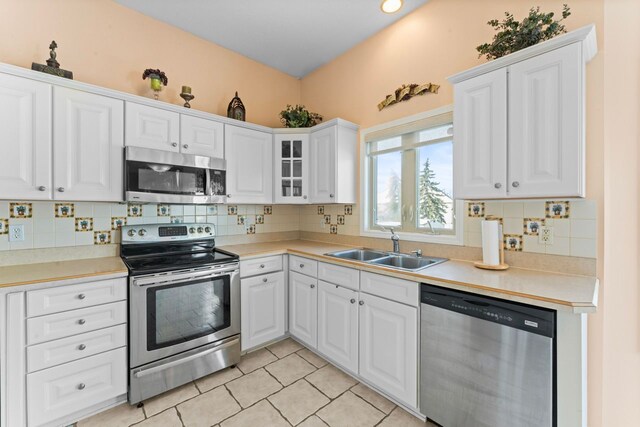 6440 Wailea Dr, Grand Blanc, MI 48439 - kitchen with white cabinets, backsplash, appliances with stainless steel finishes, and a sink