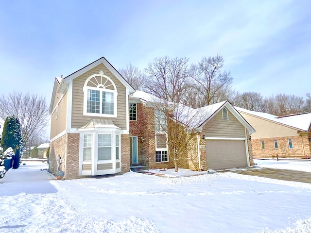 view of front of property with a garage and brick siding