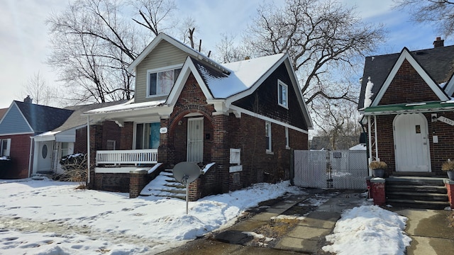 view of front of house featuring a gate and brick siding