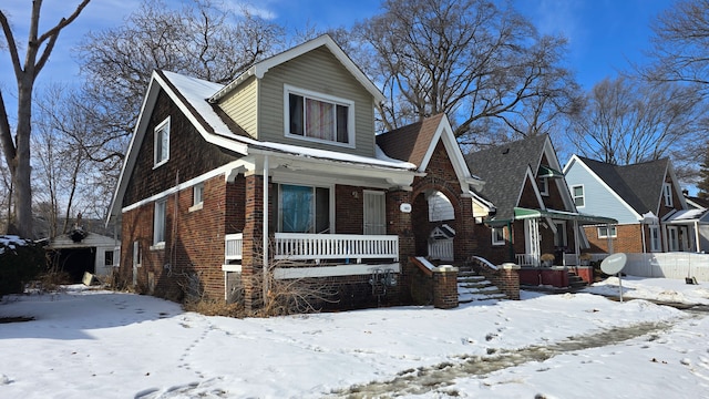 view of front of property featuring covered porch and brick siding