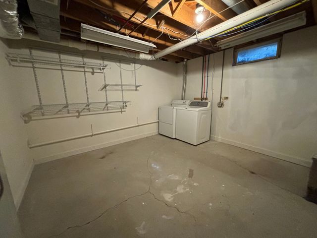 unfinished basement featuring washing machine and dryer and baseboards