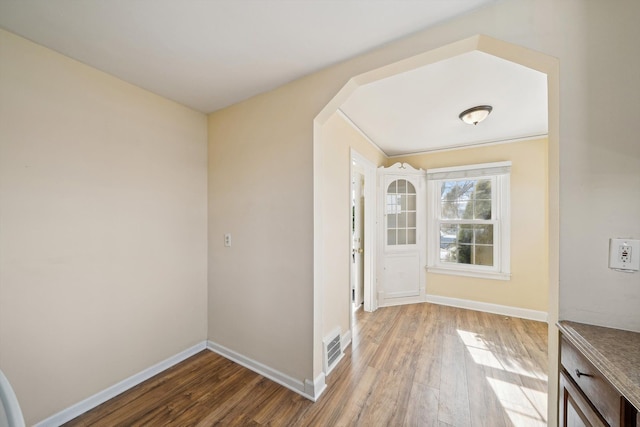 interior space featuring light wood-style floors, visible vents, and baseboards