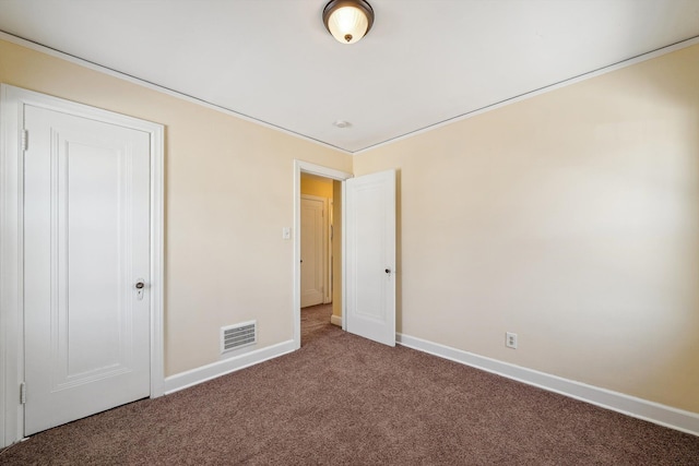 unfurnished bedroom featuring carpet floors, visible vents, and baseboards