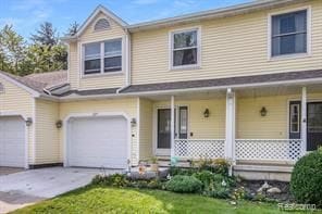 view of front of property with covered porch and concrete driveway