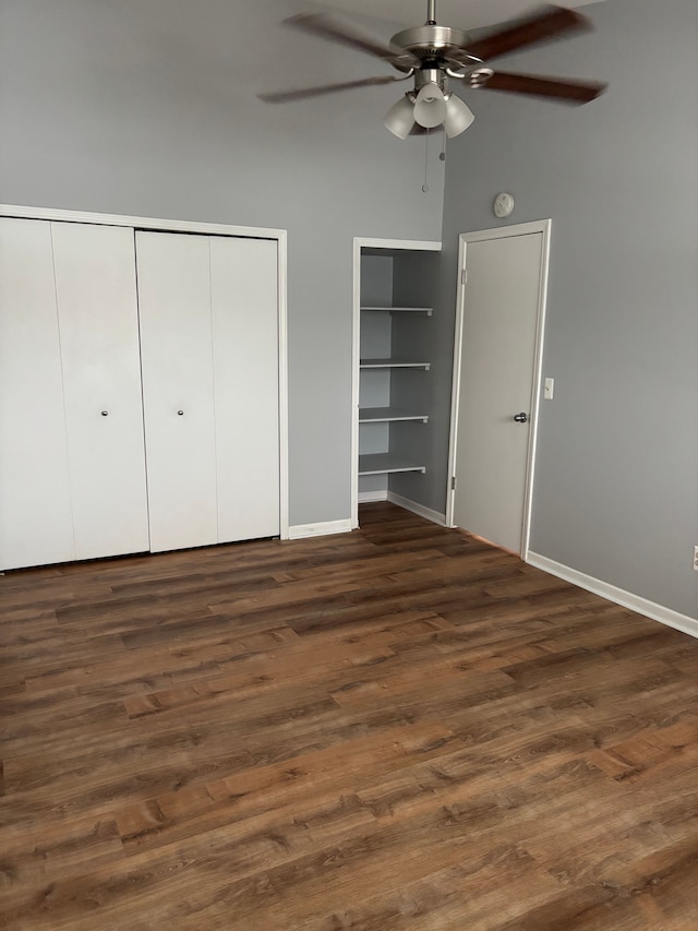 unfurnished bedroom featuring dark wood-style flooring, ceiling fan, and baseboards