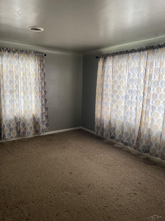 spare room with carpet floors and visible vents